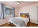 Comfortable bedroom featuring hardwood floors, ample natural light, and a calming color scheme at 1575 Verbena St, Denver, CO 80220