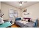 Bright bedroom featuring hardwood floors, natural light, and a comfortable daybed with stylish decor at 1575 Verbena St, Denver, CO 80220
