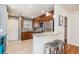 Well-lit kitchen featuring a breakfast bar, stainless steel appliances, and sleek countertops at 1575 Verbena St, Denver, CO 80220