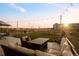 Back patio featuring seating area, fire pit, and mountain views at sunset at 1845 Meagan Way, Erie, CO 80516