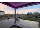 Covered back patio, perfect for outdoor dining and relaxing, with views of the surrounding landscape at 1845 Meagan Way, Erie, CO 80516