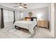 Bright bedroom with a ceiling fan, large window, and a comfortable bed and decorative rug at 1845 Meagan Way, Erie, CO 80516