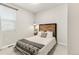 Cozy bedroom with wood headboard, neutral bedding, and soft natural light at 1845 Meagan Way, Erie, CO 80516