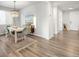 Bright dining room featuring hardwood floors, a modern light fixture and stylish decor at 1845 Meagan Way, Erie, CO 80516
