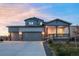 Beautiful two-story home featuring a two-car garage and inviting covered porch at 1845 Meagan Way, Erie, CO 80516