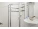 Compact bathroom featuring a glass-enclosed shower and a modern vanity at 1499 Blake St # 3M, Denver, CO 80202