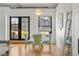 Charming dining area with a round table, upholstered chairs, and a view of the outdoor terrace through large windows at 1499 Blake St # 3M, Denver, CO 80202