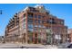Exterior elevation of a multi-story brick building with balconies and street views at 1499 Blake St # 3M, Denver, CO 80202