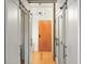 Hallway featuring exposed ductwork, barn doors, and modern lighting fixture at 1499 Blake St # 3M, Denver, CO 80202