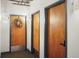 View of the hallway to the apartment unit featuring three wood doors at 1499 Blake St # 3M, Denver, CO 80202