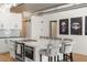 Modern kitchen featuring white cabinets, sleek appliances, a large island, and stylish decor at 1499 Blake St # 3M, Denver, CO 80202