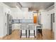 Bright, modern kitchen with white cabinets, stainless steel appliances, and a large central island with seating at 1499 Blake St # 3M, Denver, CO 80202