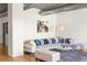 Cozy living room with a plush sectional sofa, stylish rug, and exposed ductwork, offering an urban feel at 1499 Blake St # 3M, Denver, CO 80202
