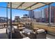 The patio has ample seating with outdoor furniture and a beautiful city view at 1499 Blake St # 3M, Denver, CO 80202