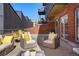 This patio has comfortable wicker seating with yellow pillows and a gray brick surround at 1499 Blake St # 3M, Denver, CO 80202