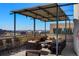 This patio has ample seating with outdoor furniture and mountain views at 1499 Blake St # 3M, Denver, CO 80202