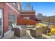 This spacious patio has stylish wicker furniture, gray trim, and ample seating at 1499 Blake St # 3M, Denver, CO 80202