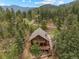 Aerial view of a home nestled among lush trees at 32462 Lodgepole Dr, Evergreen, CO 80439