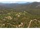 Wonderful aerial view of the community surrounded by trees and lush green landscaping at 32462 Lodgepole Dr, Evergreen, CO 80439
