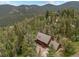 Scenic aerial view of a charming home nestled in a wooded area at 32462 Lodgepole Dr, Evergreen, CO 80439