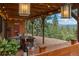 Inviting back patio with wood features overlooking lush greenery and mountain views at 32462 Lodgepole Dr, Evergreen, CO 80439