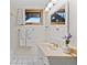 Bathroom with white tiling, vanity, and a window, providing natural light at 32462 Lodgepole Dr, Evergreen, CO 80439