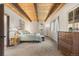 Cozy bedroom with a wood-beamed ceiling, neutral walls and carpet, and a queen bed at 32462 Lodgepole Dr, Evergreen, CO 80439