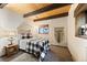 Bedroom featuring a bed with a black and white comforter and exposed wood beams at 32462 Lodgepole Dr, Evergreen, CO 80439