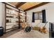 Charming bonus room features wood ceiling beams, shelving and natural light from the window at 32462 Lodgepole Dr, Evergreen, CO 80439
