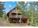Exterior of a multi-level home featuring balconies and natural surroundings at 32462 Lodgepole Dr, Evergreen, CO 80439