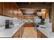 Well-lit kitchen featuring wooden cabinets, stainless steel appliances, and white countertops at 32462 Lodgepole Dr, Evergreen, CO 80439