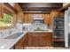 Charming kitchen featuring wood cabinets, stainless steel appliances, and bright white countertops at 32462 Lodgepole Dr, Evergreen, CO 80439