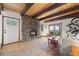 Bright living room with tile floors, rustic stone fireplace, and a sliding door at 32462 Lodgepole Dr, Evergreen, CO 80439