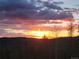 Magnificent sunset over tree tops with stunning colors of orange and purple painting the horizon at 32462 Lodgepole Dr, Evergreen, CO 80439