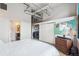Bedroom with large media display and in-unit washer and dryer behind sliding closet doors at 1801 Wynkoop St # 208, Denver, CO 80202