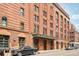 Street perspective of the Ice House, highlighting its brick facade, historic details, and prominent signage at 1801 Wynkoop St # 208, Denver, CO 80202
