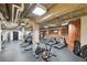 Gym with multiple machines and exposed brick at 1801 Wynkoop St # 208, Denver, CO 80202