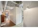 Hallway featuring hardwood floors with an adjacent laundry room with a stackable washer and dryer at 1801 Wynkoop St # 208, Denver, CO 80202