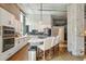 Spacious kitchen featuring modern appliances, exposed ductwork, large island with seating, and adjoining living space at 1801 Wynkoop St # 208, Denver, CO 80202