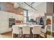 Well-appointed kitchen featuring white cabinets, stainless steel appliances, stylish backsplash, and island with seating at 1801 Wynkoop St # 208, Denver, CO 80202