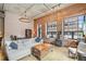 Stylish living room with exposed brick, large windows, and comfortable seating, blending historic charm with modern elegance at 1801 Wynkoop St # 208, Denver, CO 80202