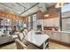 Inviting living room and kitchen featuring island seating, stainless appliances, exposed brick and large windows at 1801 Wynkoop St # 208, Denver, CO 80202