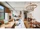 Bright and airy living room and kitchen featuring exposed brick and ductwork, island seating, and a modern light fixture at 1801 Wynkoop St # 208, Denver, CO 80202