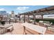 Spacious rooftop deck with a pergola, stylish seating, and city skyline views at 1801 Wynkoop St # 208, Denver, CO 80202
