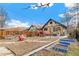 Backyard features an 'EAT' sign, red umbrella, patio set, and blue raised garden beds at 2663 King St, Denver, CO 80211