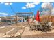 Inviting backyard with patio, string lights, sheds, table and chairs perfect for relaxing or entertaining at 2663 King St, Denver, CO 80211