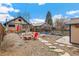 Backyard with a seating area, garden beds and a shed, with a view of surrounding homes at 2663 King St, Denver, CO 80211