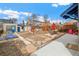 Wide backyard features string lights, patio seating, sheds, blue raised garden beds, and an 'EAT' sign at 2663 King St, Denver, CO 80211