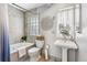 Bright bathroom featuring a shower/tub, toilet, pedestal sink, and decorative wall art at 2663 King St, Denver, CO 80211