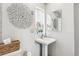 Updated bathroom with pedestal sink and a decorative accent at 2663 King St, Denver, CO 80211